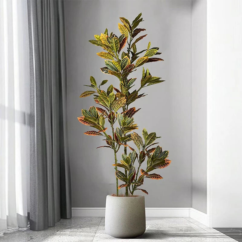 Artificial plant in a pot on a gray floor with a neutral background