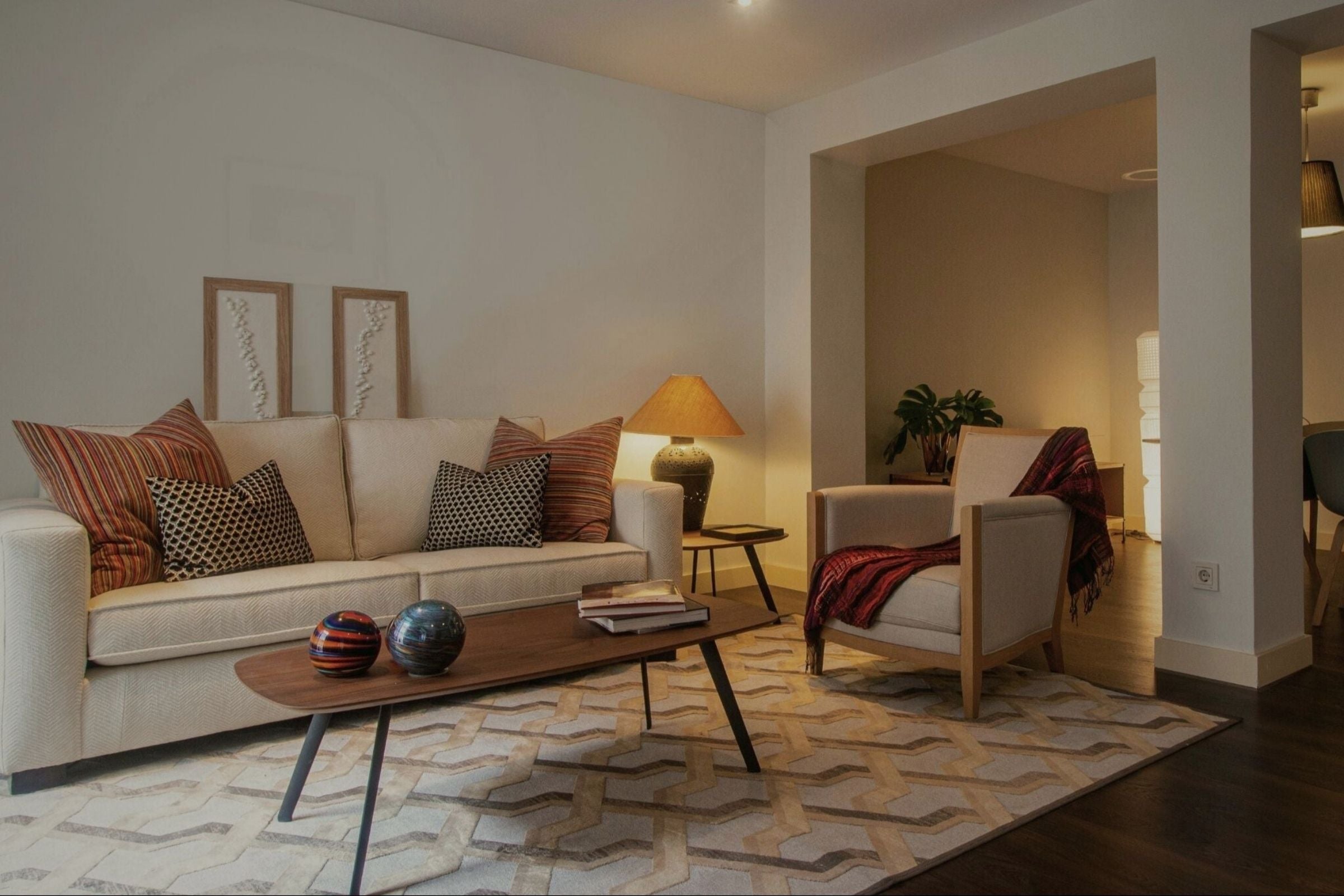 Living room with a beige sofa, coffee table, and armchair.