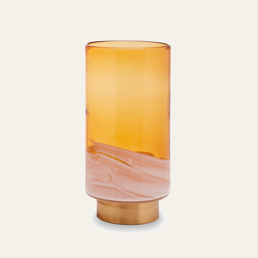 Amalia Amber Glass Vase – tall cylindrical amber glass with a swirled milky-white band near the base, sitting on a short gold-tone metal pedestal