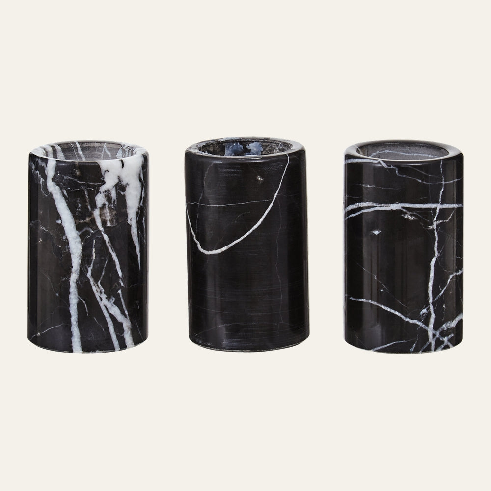 Anoria Tealight Holder Set — three cylindrical black marble tealight holders with white veining and polished finish, arranged side by side