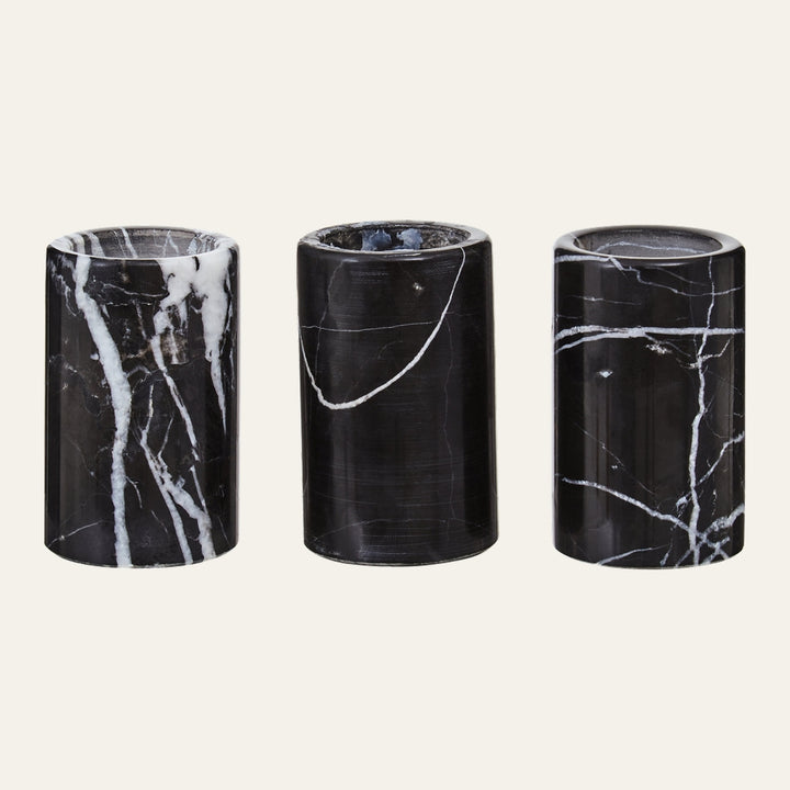 Anoria Tealight Holder Set — three cylindrical black marble tealight holders with white veining and polished finish, arranged side by side