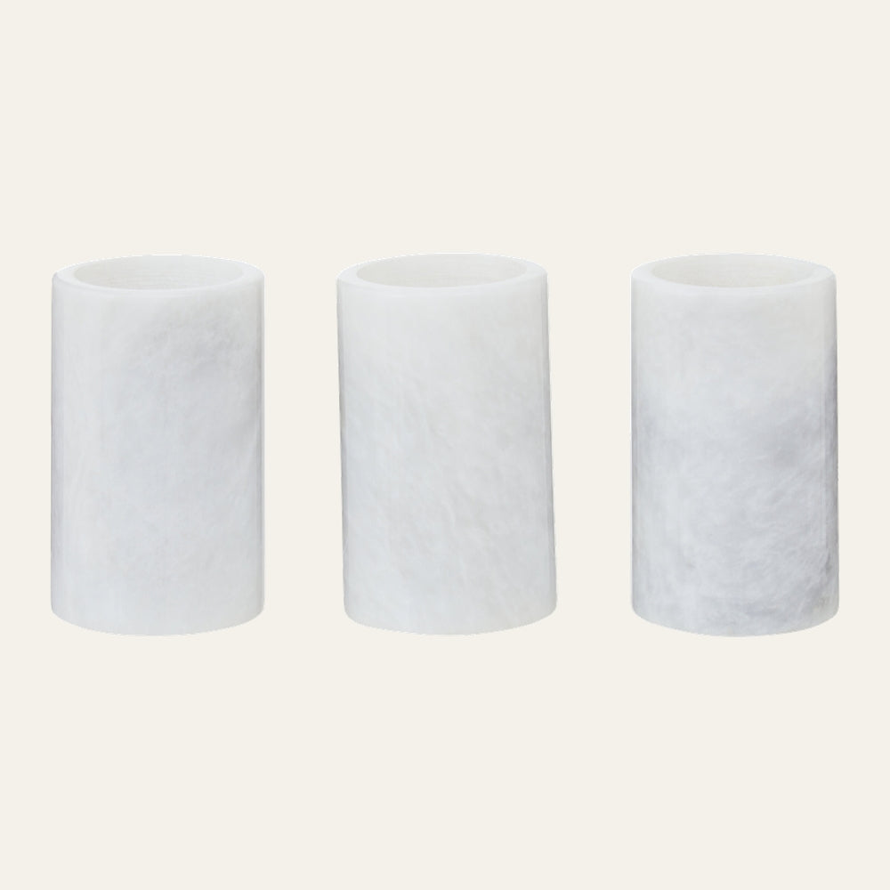 Anoria Tealight Holder Set — three cylindrical white tealight holders with soft marbled texture and open tops on a light background