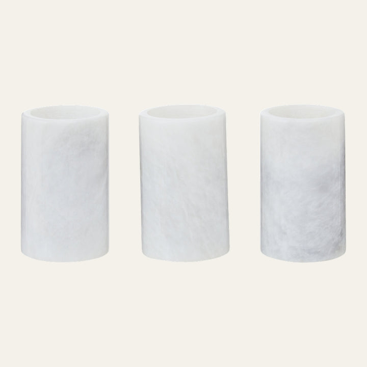 Anoria Tealight Holder Set — three cylindrical white tealight holders with soft marbled texture and open tops on a light background