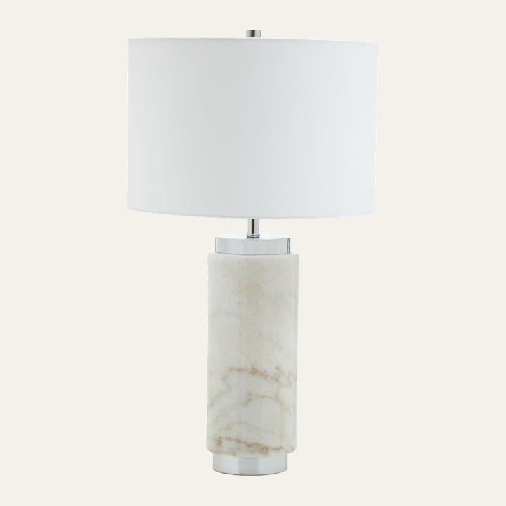 Arelia Marble Table Lamp with cylindrical cream-and-beige veined marble base, polished chrome accents, and a white drum fabric shade