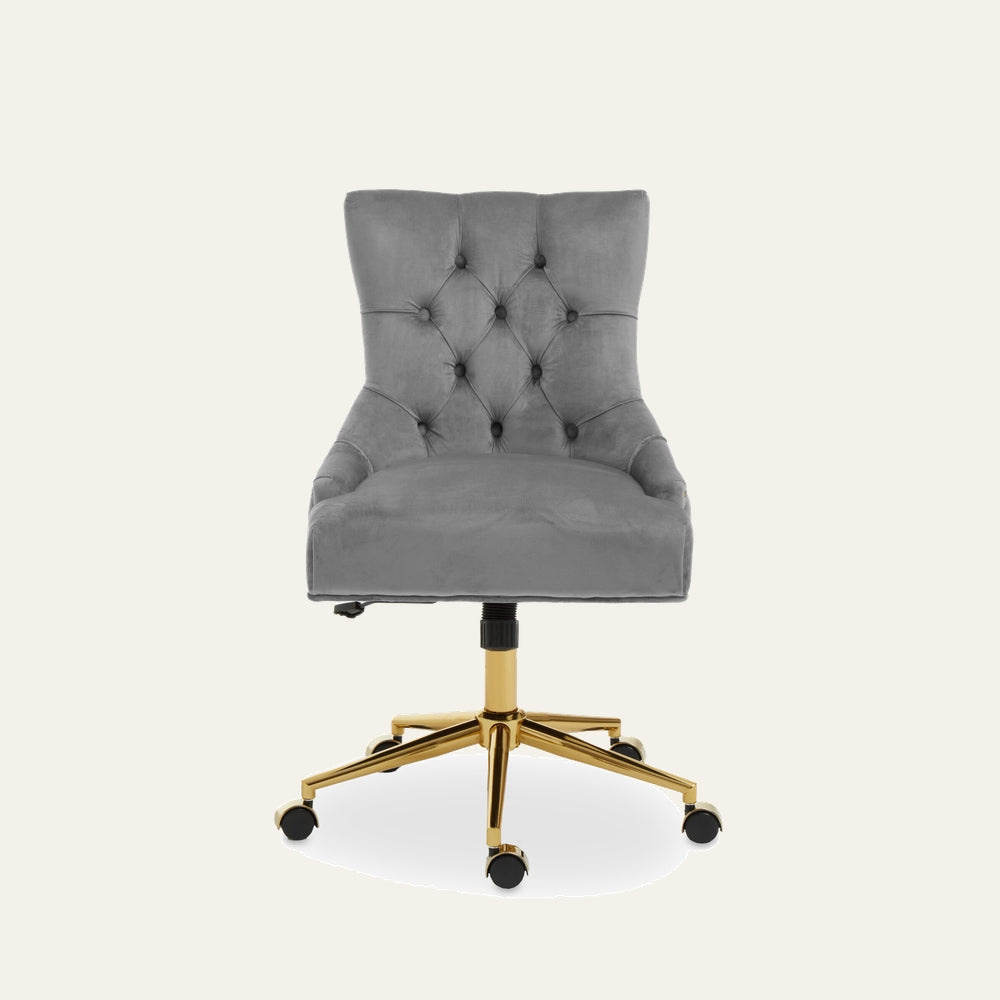 Arkor Velvet Desk Chair — gray velvet seat with button-tufted back and contoured sides, gold metal five-star base with caster wheels and visible height-adjust lever.