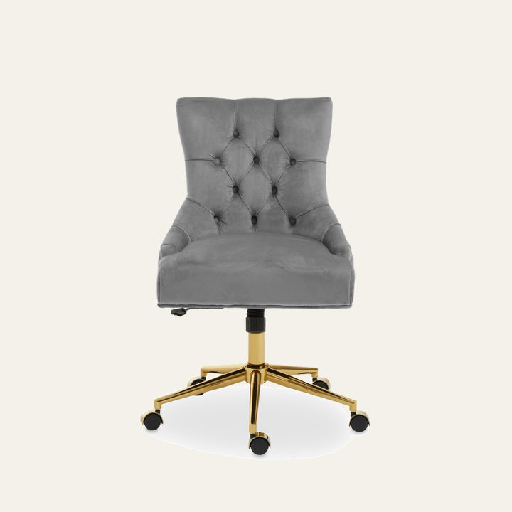 Arkor Velvet Desk Chair — gray velvet seat with button-tufted back and contoured sides, gold metal five-star base with caster wheels and visible height-adjust lever.