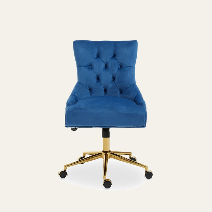 Arkor Velvet Desk Chair in royal blue velvet with tufted button back, padded seat and curved sides on a gold metal swivel base with caster wheels