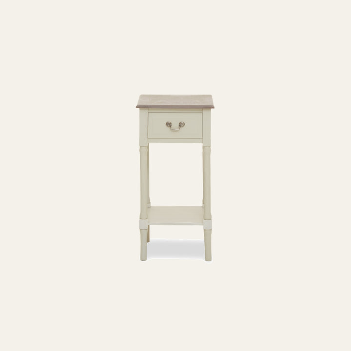 Arlen Ivory Wood Side Table — slim single-drawer side table with turned legs and lower shelf, ivory painted wood body, contrasting natural wood top and metal bail drawer pull