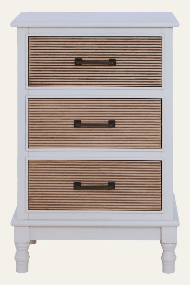 Arlen White Wood Chest of Drawers — three-drawer white painted wood chest with ribbed light-wood drawer fronts and dark metal bar handles, turned legs