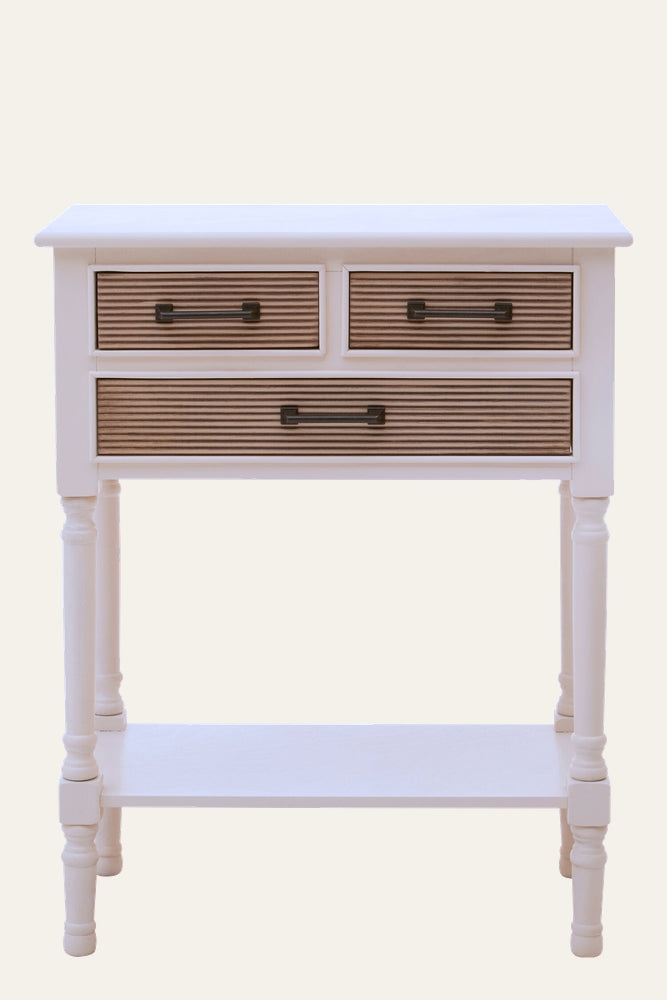 Arlen White Wood Console Table with white painted wood frame, turned legs and lower shelf, three drawers with ribbed natural wood fronts and dark metal handles