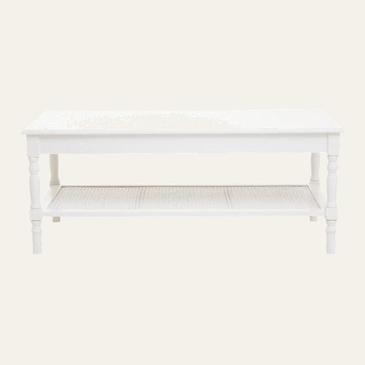 Arlen Wood Coffee Table with rectangular white painted wood top, turned legs, and a lower woven cane shelf