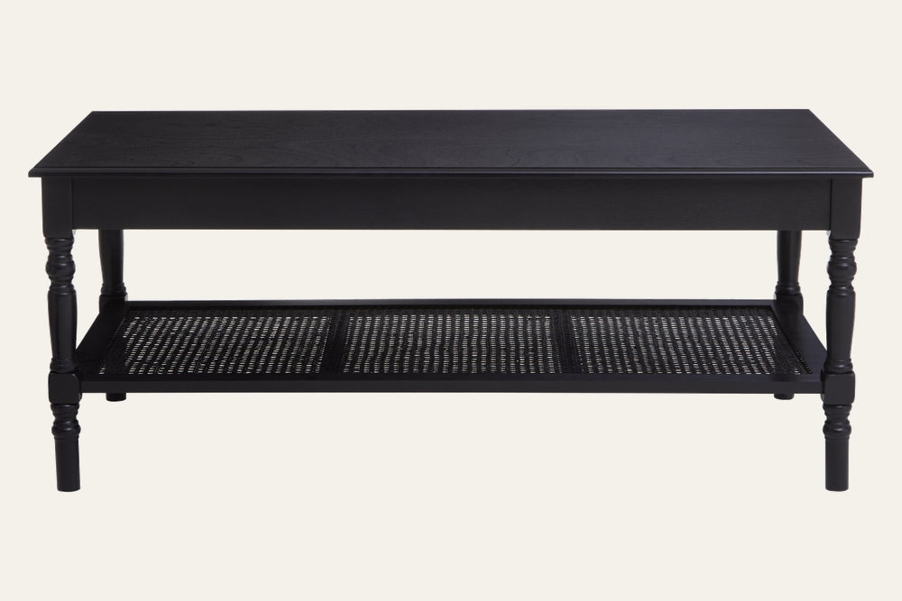 Arlen Wood Coffee Table with rectangular black wood top, turned legs, and woven cane lower shelf.