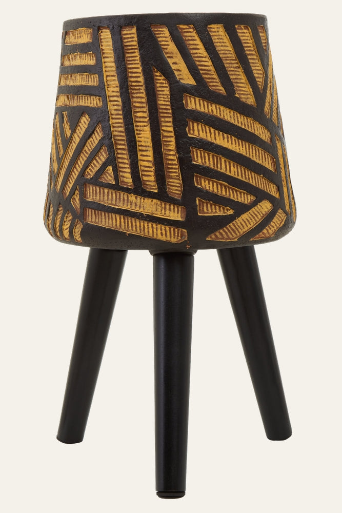Arric Angular Leg Planter — textured black pot with carved gold geometric stripe pattern resting on three tapered matte black legs