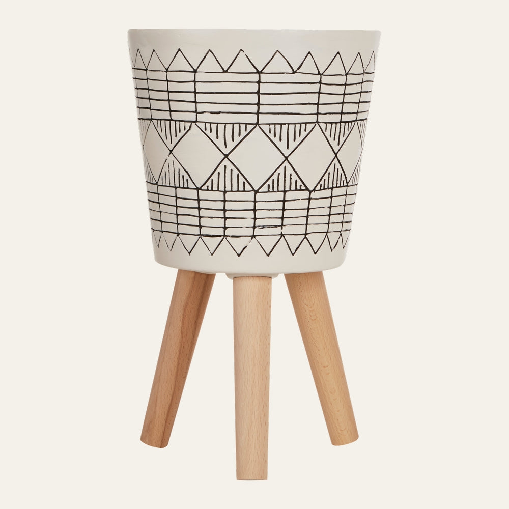Arric Black White Planter — white ceramic planter with black hand-drawn geometric pattern (diamonds and grid) on a natural light wood tripod stand