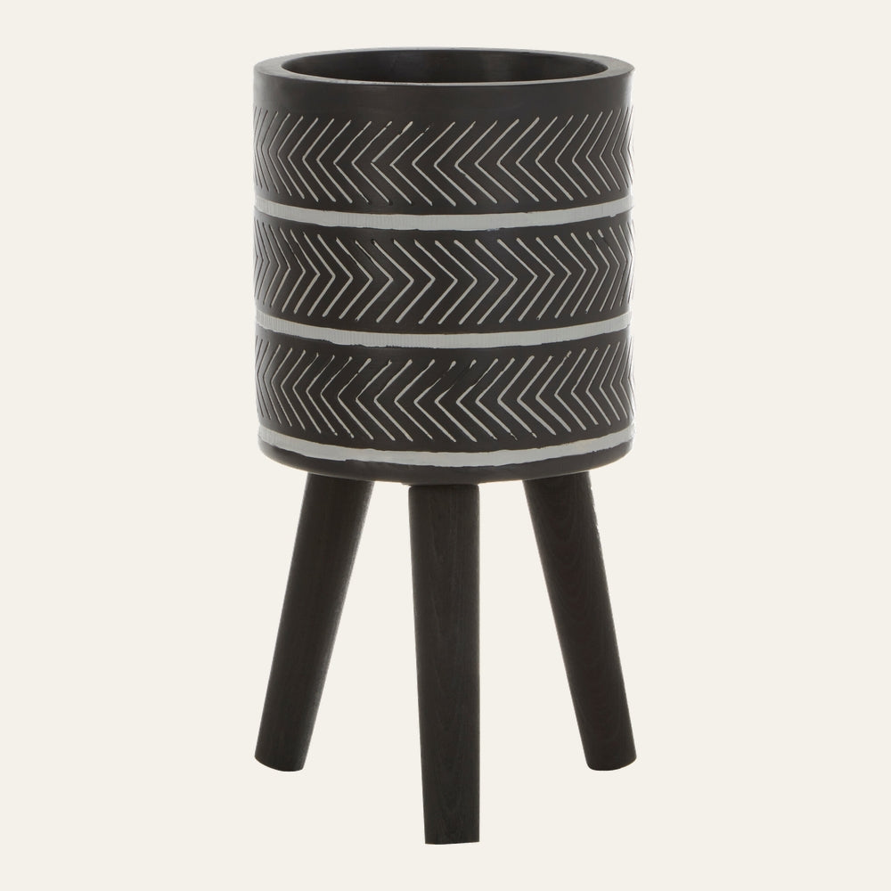 Arric Planter — black cylindrical planter with white chevron stripe bands, supported by three dark wood legs