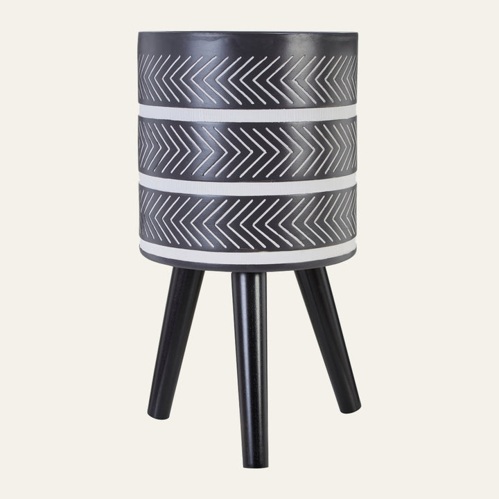 Arric Planter — black cylindrical planter with white chevron and horizontal bands, on three black tapered legs