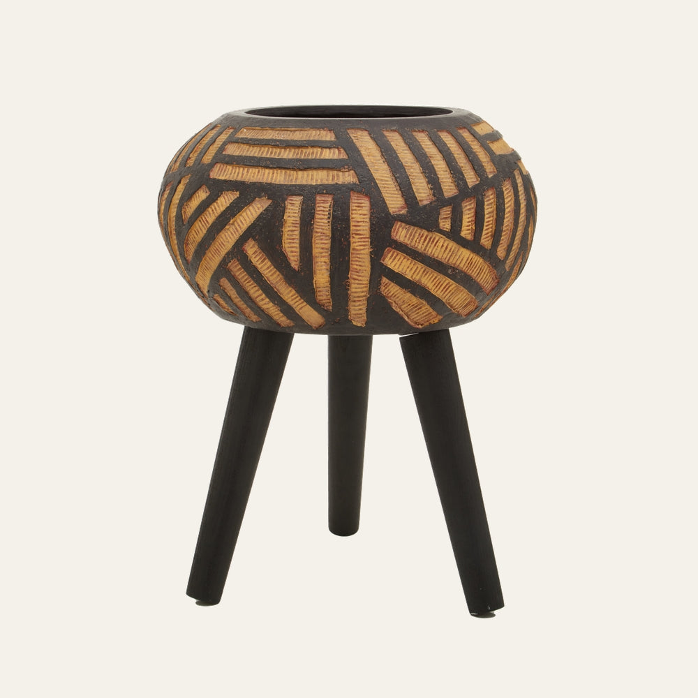 Arric Tapered Resin Planter — round black resin planter with carved tan geometric stripe pattern and small top opening, mounted on three tapered black legs
