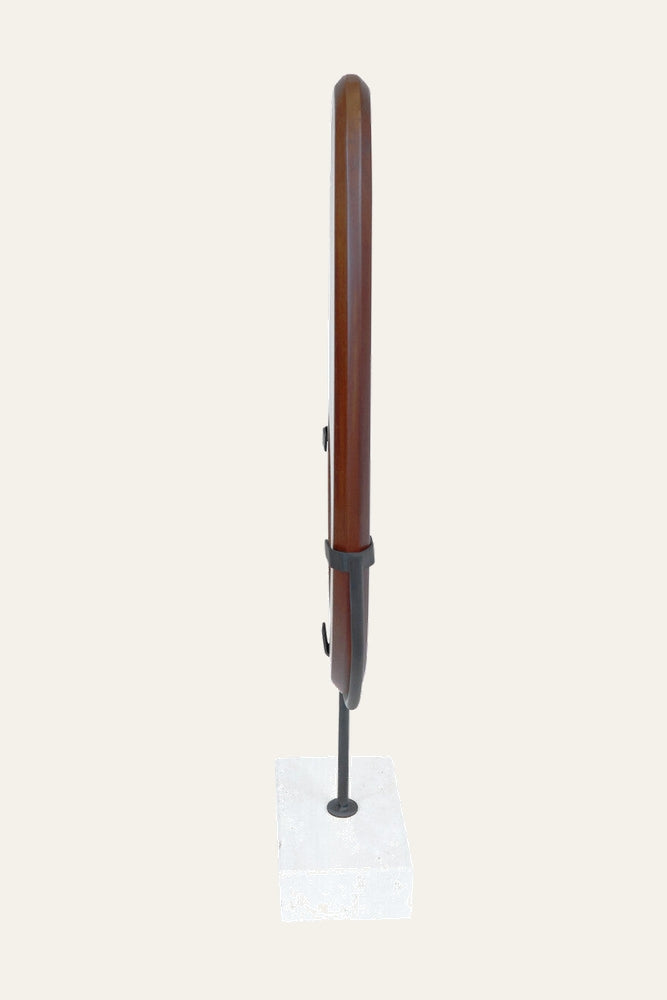 Arsen Wood Vertical Sculpture with a slender polished brown wood column, rounded top, secured by black metal brackets on a thin black rod and white square stone base.