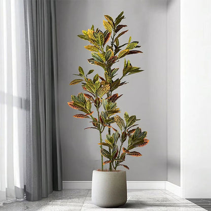 Artificial plant in a pot on a gray floor with a neutral background