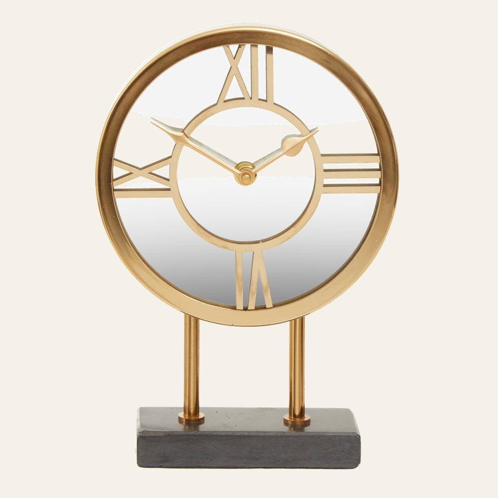 Artor Marble Clock — round gold metal open-face clock with Roman numerals and mirrored center, mounted on two gold posts and a rectangular dark marble base