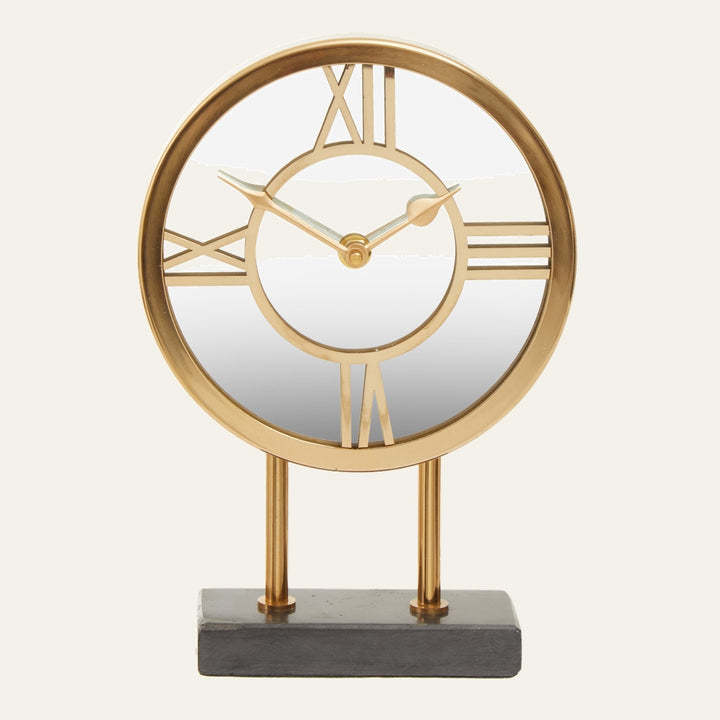 Artor Marble Clock — round gold metal open-face clock with Roman numerals and mirrored center, mounted on two gold posts and a rectangular dark marble base