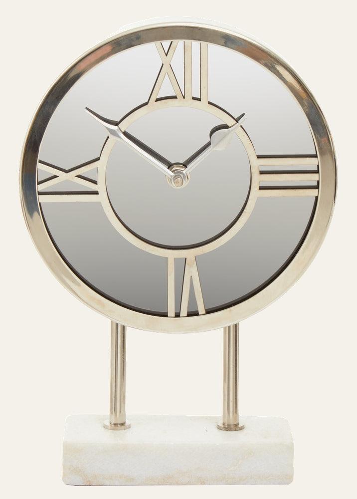 Artor Marble Clock with round mirrored face, metal Roman numerals and hands mounted on two polished metal posts and a white rectangular marble base.