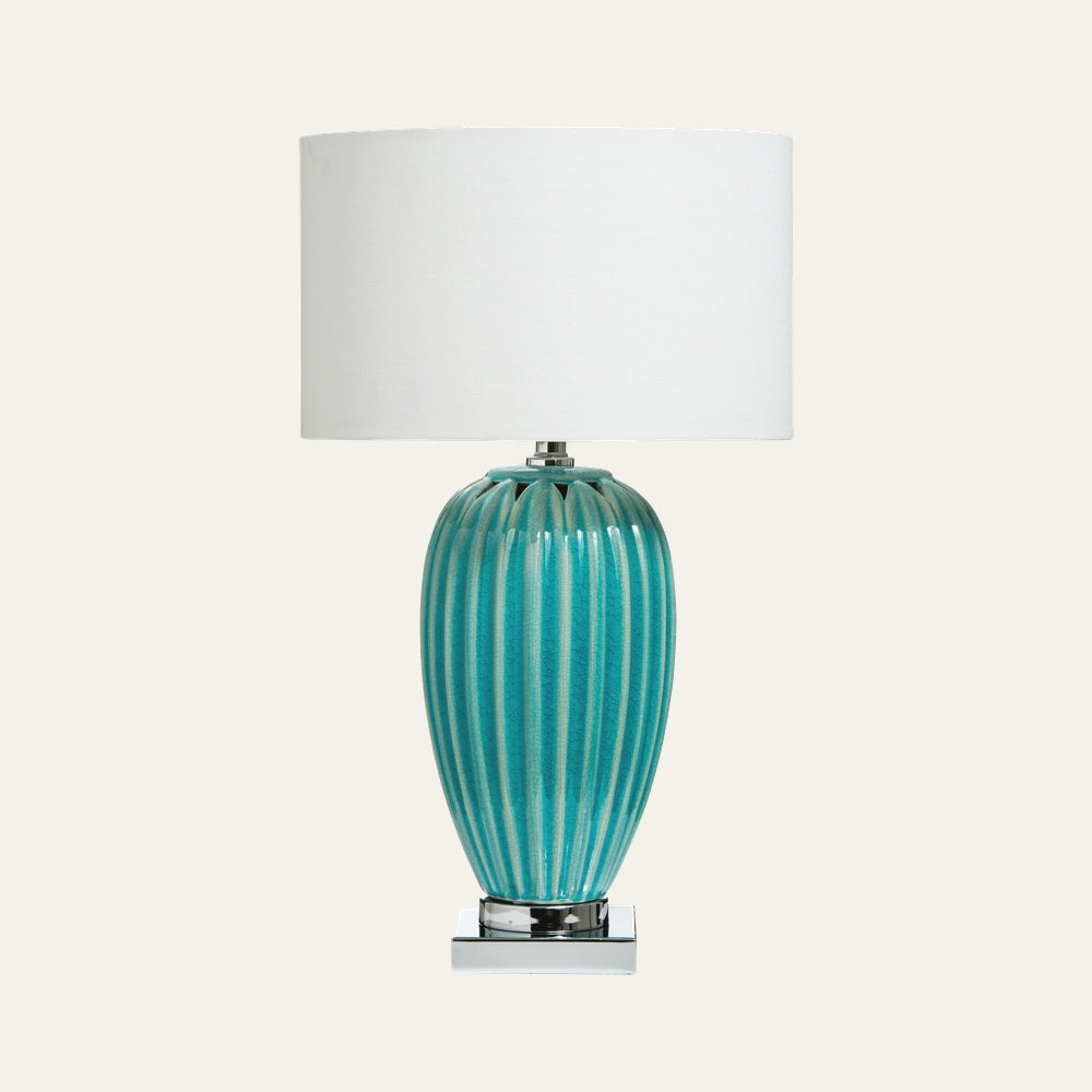 Avia Ceramic Table Lamp with turquoise ribbed glazed ceramic vase base, chrome square pedestal, and white drum fabric shade.