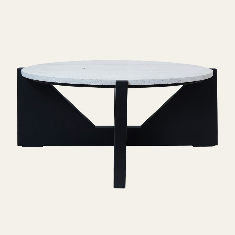 Belin Travertine Coffee Table with round white travertine top and black geometric metal base featuring triangular cutouts