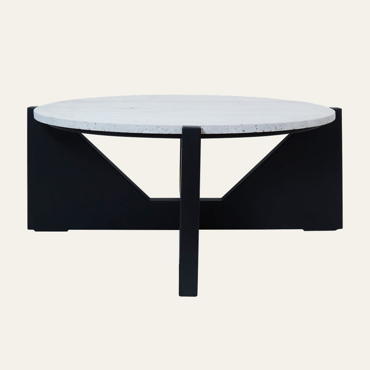 Belin Travertine Coffee Table with round white travertine top and black geometric metal base featuring triangular cutouts