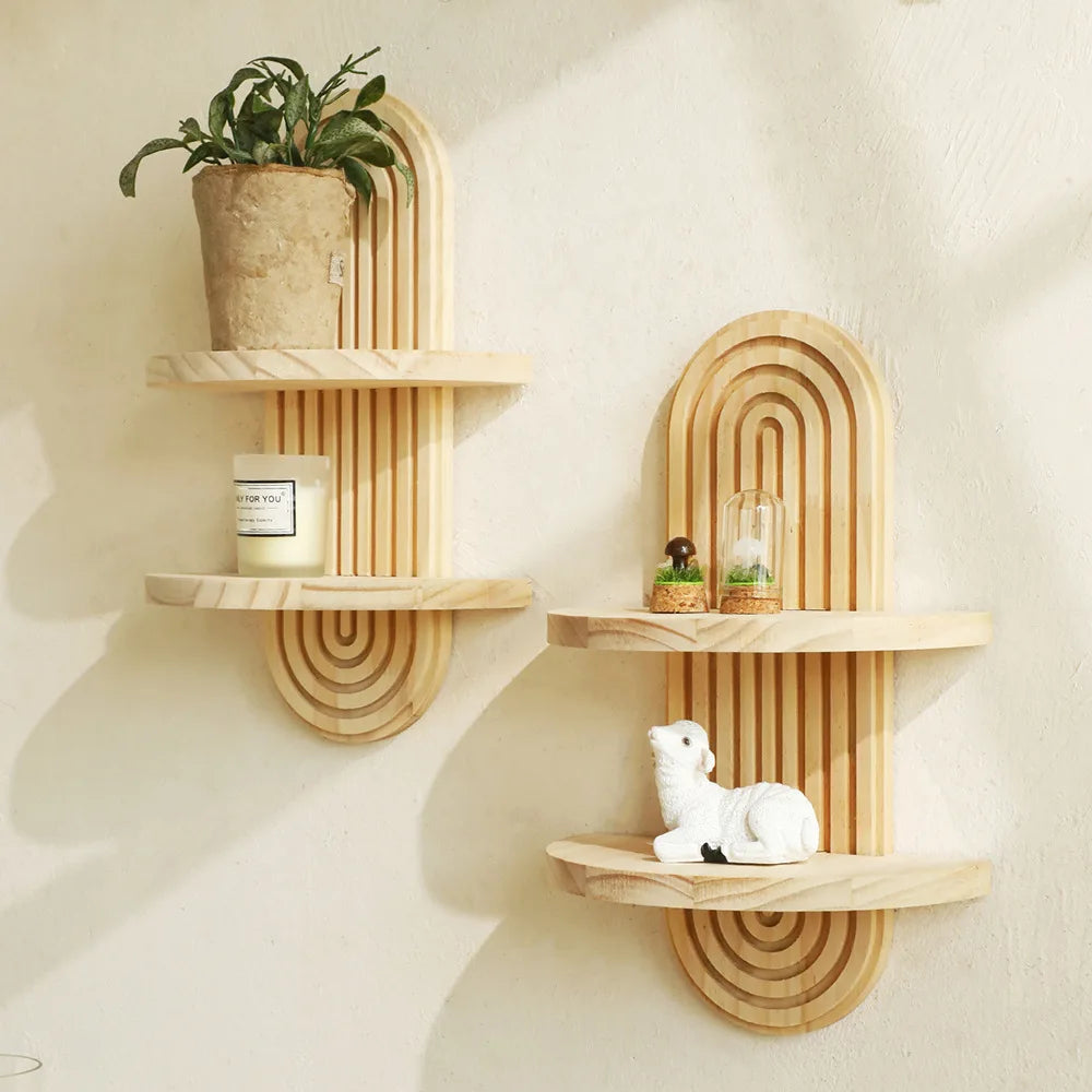Wooden wall shelves with decorative items on a light beige wall