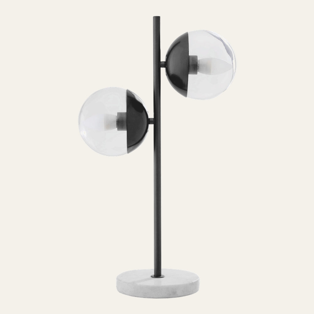 Brric Marble Table Lamp with round white marble base, slim black metal rod and two clear glass globe shades with half-black metal caps showing inner bulbs