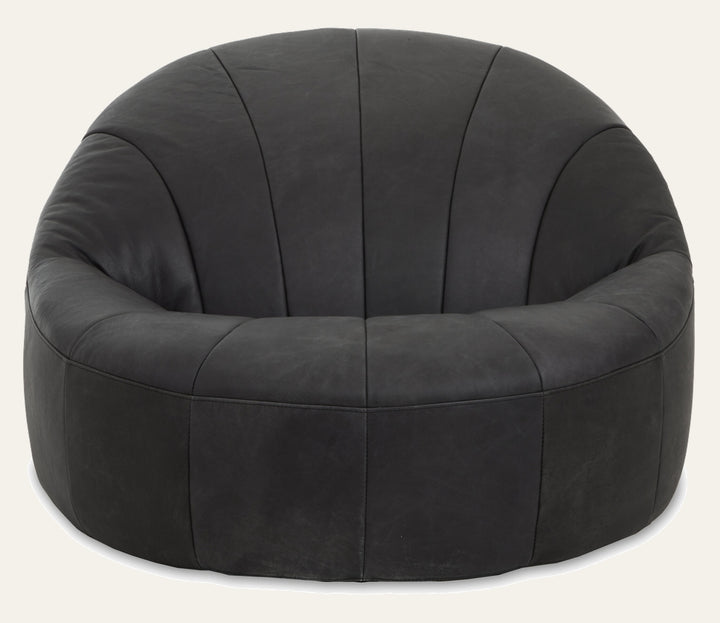 Caelver Accent Chair, round low-profile bucket chair in dark charcoal leather with vertical stitched panels and plush padded seat and arms.