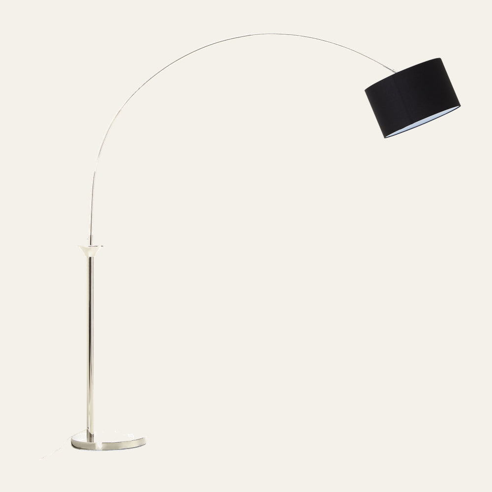 Caesira Nickel Metal Floor Lamp with arched nickel metal arm, slender polished nickel pole and round base topped by a black drum shade