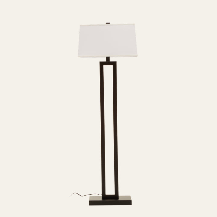 Celdora Floor Lamp with tall rectangular open-frame in matte black finish, flat rectangular base, white rectangular fabric shade and visible power cord