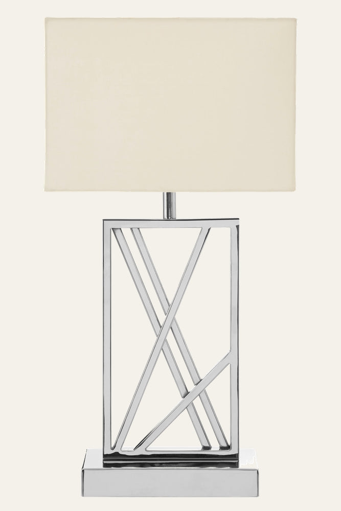 Celesse Metal Table Lamp — rectangular cream fabric shade over polished chrome geometric open-frame base with intersecting diagonal bars on a chrome pedestal