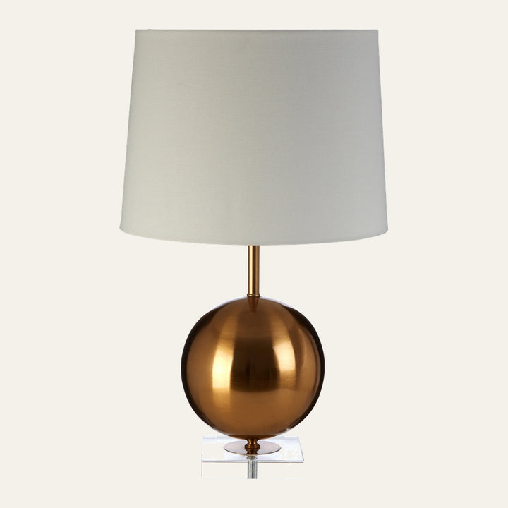 Celmira Gold Sphere Table Lamp with polished gold spherical metal base, slim gold stem, clear acrylic square foot, and white fabric drum shade