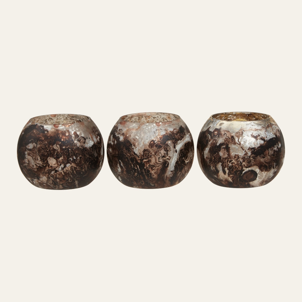 Celthea Marble Tealight Holder Set — three round marble-patterned tealight holders in swirled brown and cream with gold-toned interiors