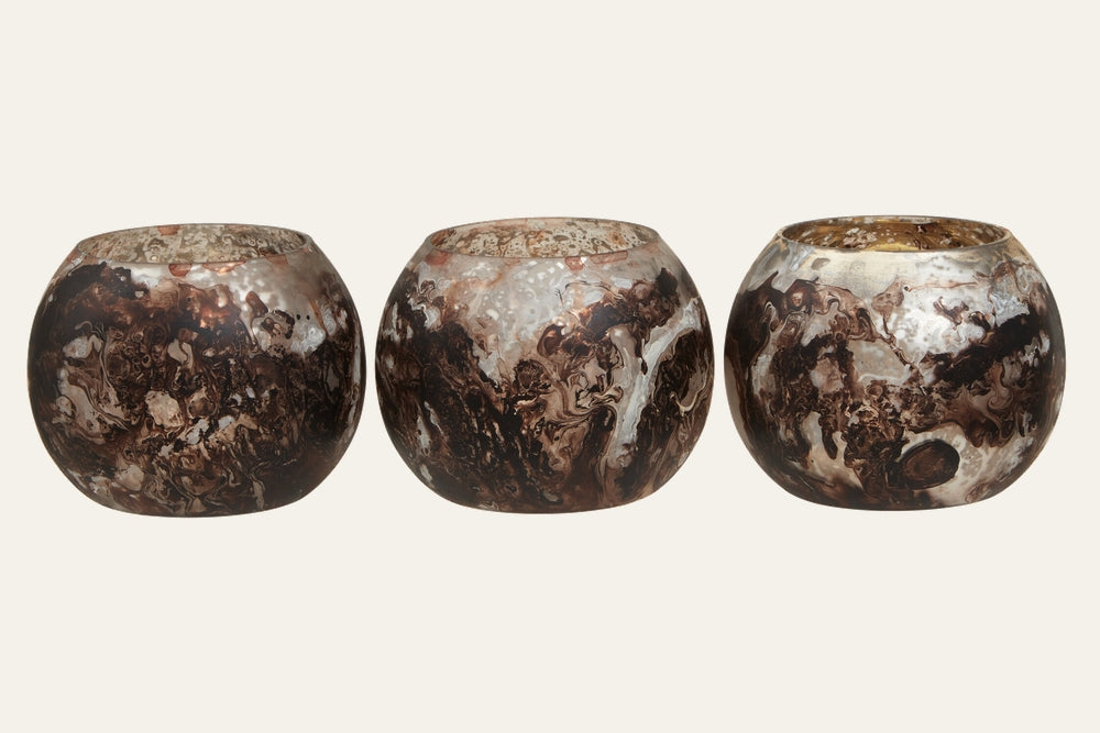 Celthea Marble Tealight Holder Set — three round marbled holders with brown and cream swirls, glossy finish and gold-toned interiors.