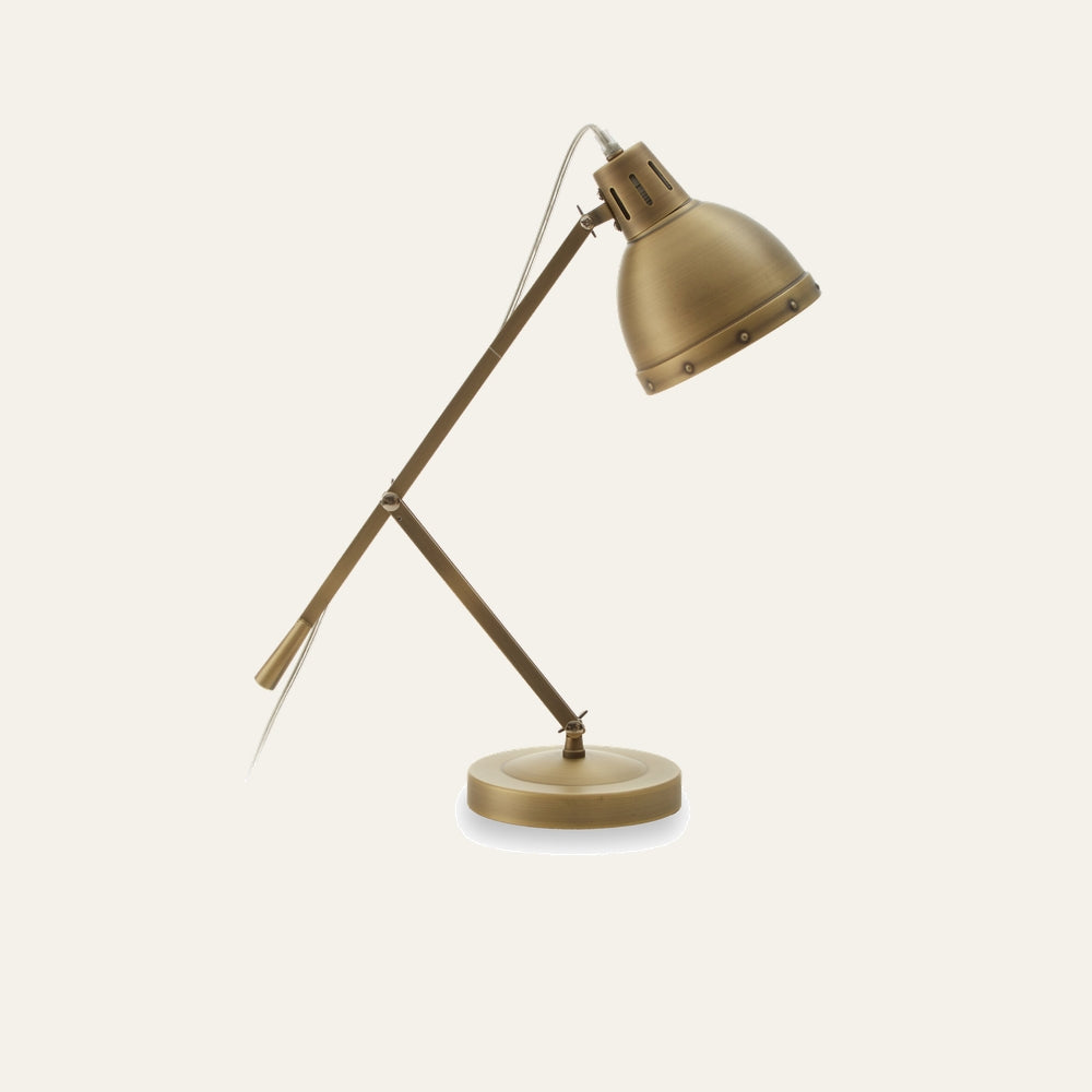 Corar Adjustable Brass Desk Lamp — articulating two-arm desk lamp in brushed brass finish with dome shade, rivet detail and round weighted base