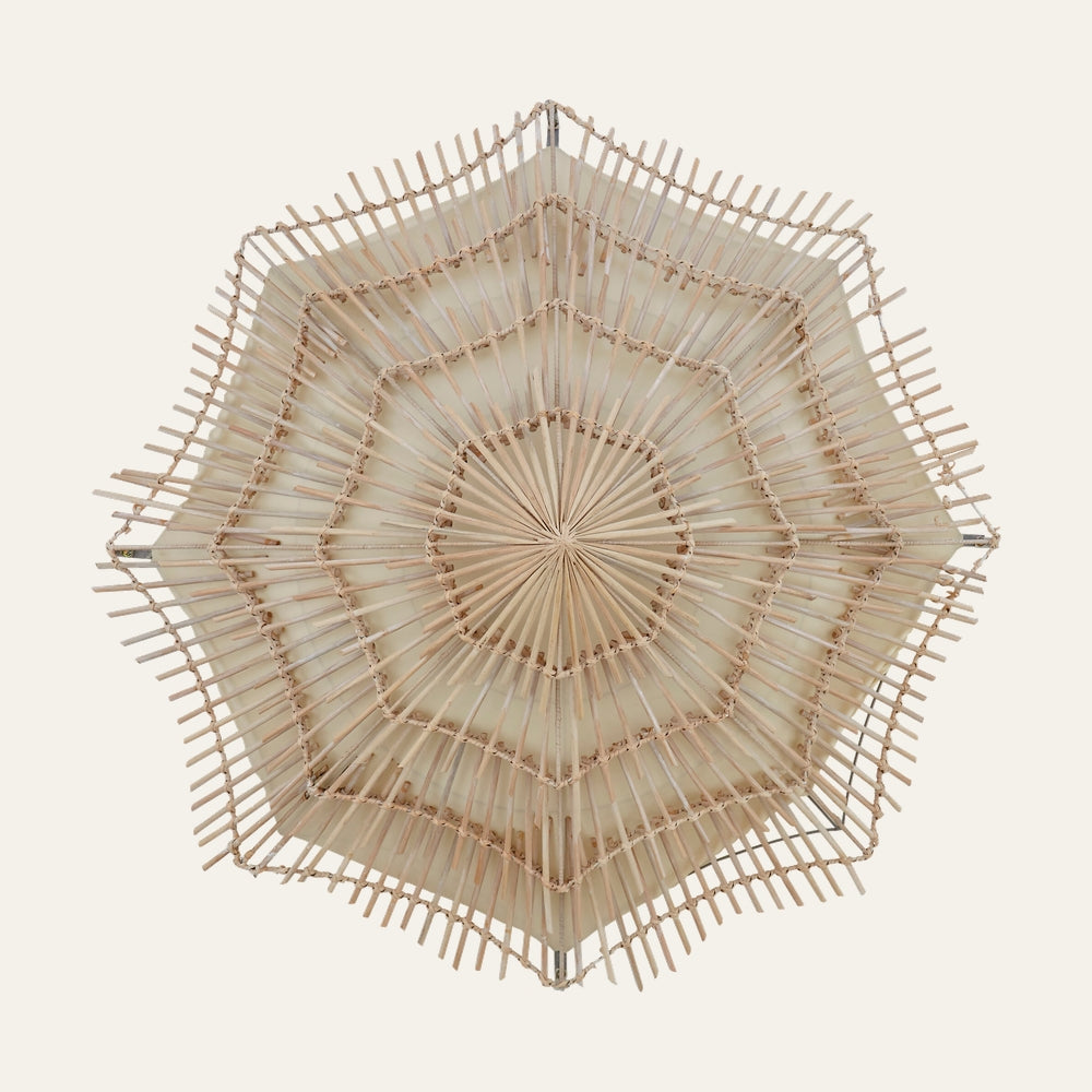 Corric Rattan Woven Wall Light with layered starburst hexagonal rattan weave, radial spokes and cream inner backing in natural finish