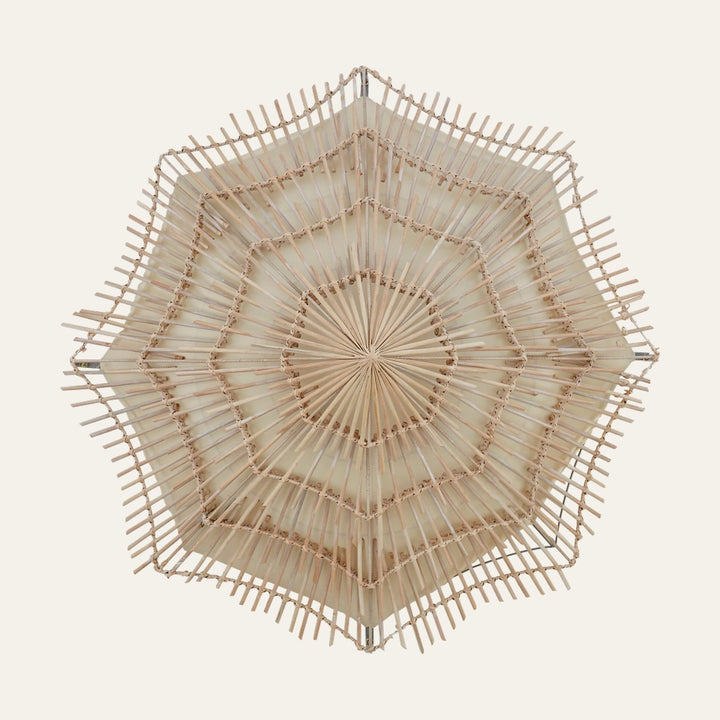 Corric Rattan Woven Wall Light with layered starburst hexagonal rattan weave, radial spokes and cream inner backing in natural finish