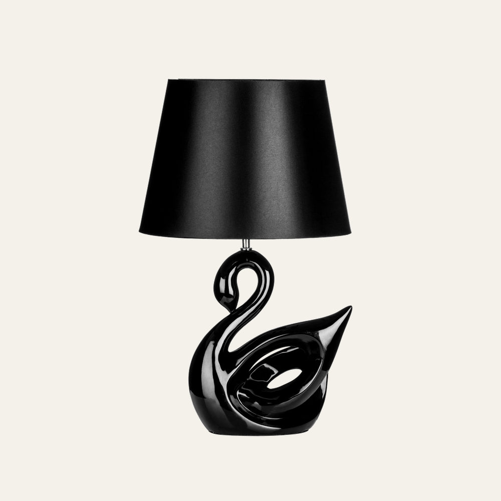 Corver Swan Resin Table Lamp with glossy black swan-shaped resin base and black tapered fabric lampshade