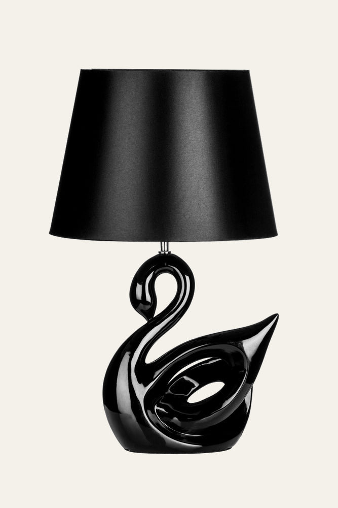 Corver Swan Resin Table Lamp — glossy black resin swan-shaped base with sculptural cutout and curved neck, topped by a black tapered fabric shade