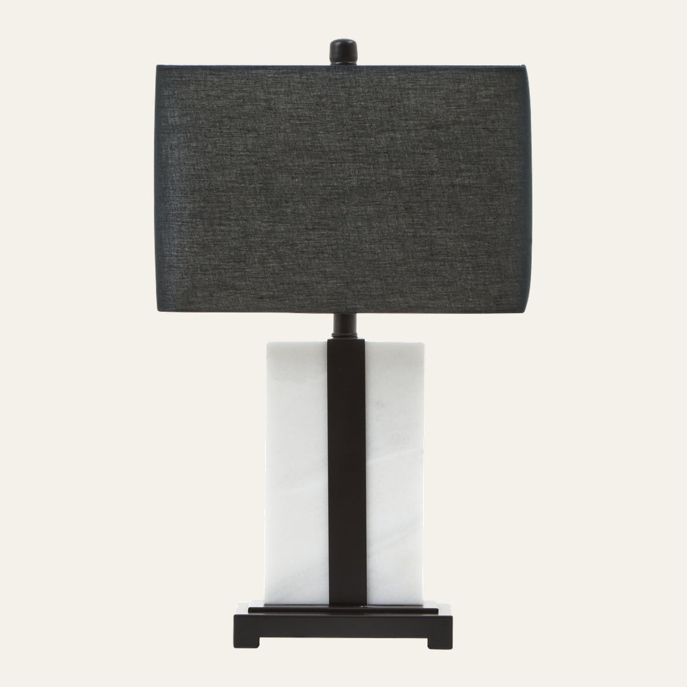 Doran Marble Table Lamp with rectangular dark gray fabric shade above a white rectangular marble column base accented by a central black metal strip and black platform base.