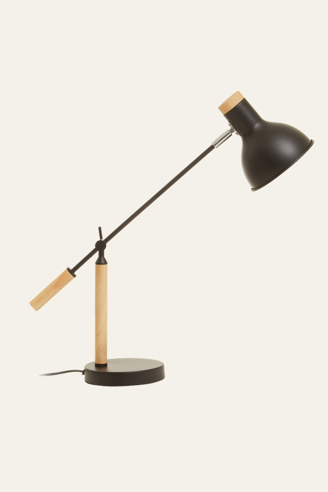 Dorlin Matte Black Table Lamp with adjustable angled matte-black metal shade and arm, light wood stem and handle, round black base and visible cord