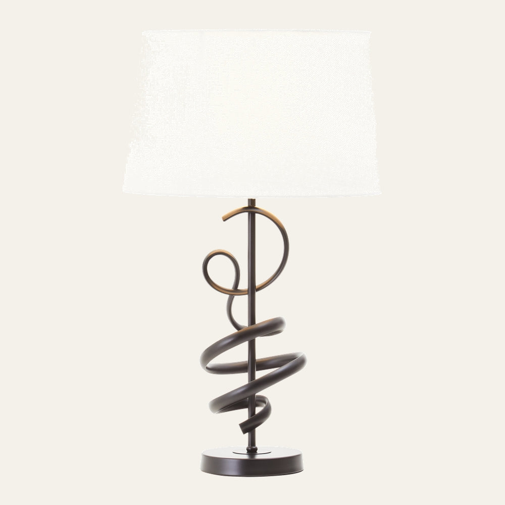 Dorrel Squiggle Table Lamp with white fabric drum shade and dark bronze squiggle metal base on round pedestal