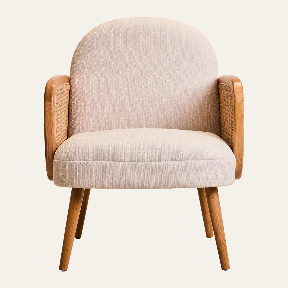 Drevan Cane Fabric Chair with light beige rounded fabric seat and back, tapered light wood legs and armrests with woven cane panels