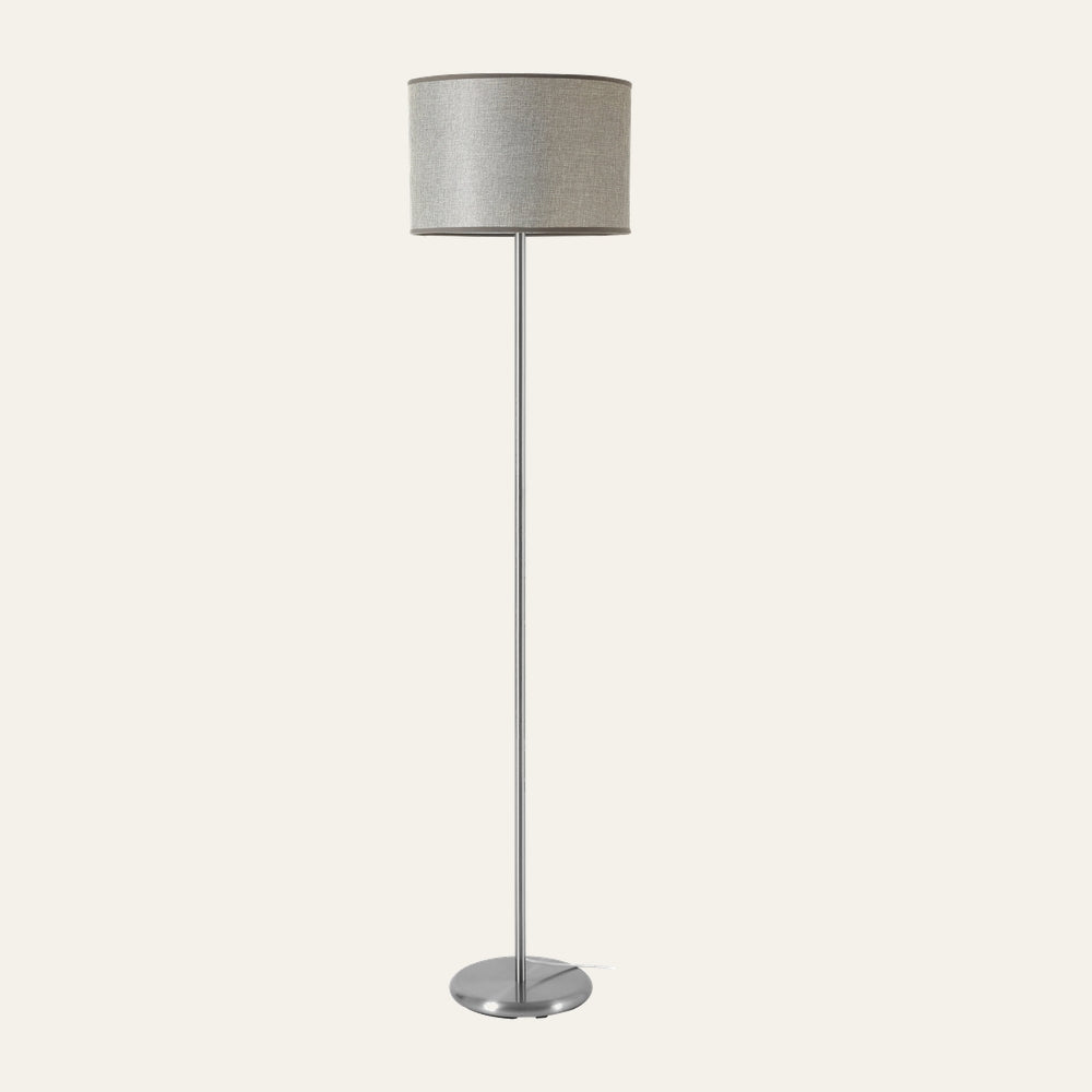 Elara Floor Lamp with a slim brushed silver metal pole and round base, topped by a light gray textured fabric drum shade with dark trim.