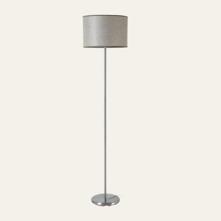 Elara Floor Lamp with a slim brushed silver metal pole and round base, topped by a light gray textured fabric drum shade with dark trim.