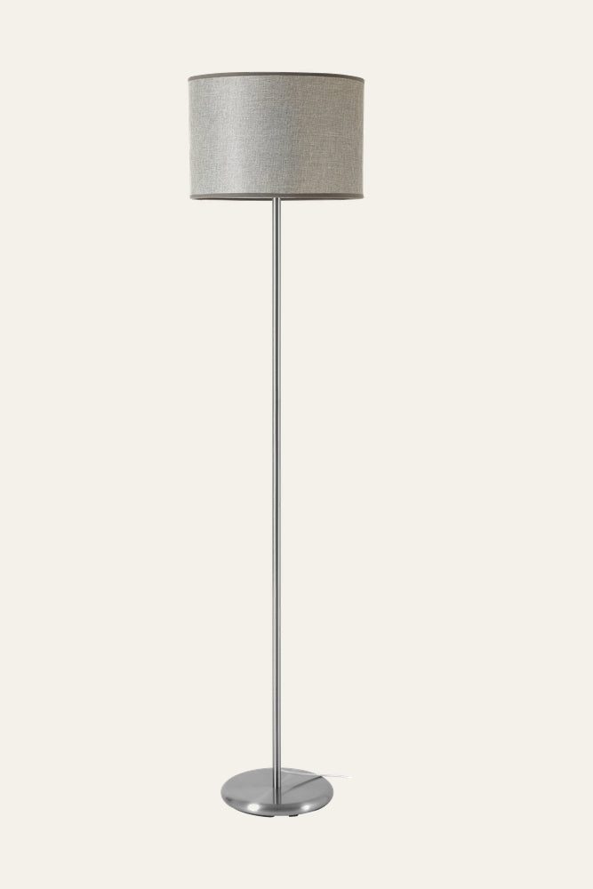Elara Floor Lamp with slim chrome metal pole and round metal base, topped by a light gray fabric drum shade